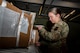 Airman 1st Class Emily Leavitt, Traffic Management Office inbound cargo technician, opens a piece of cargo at Minot Air Force Base, North Dakota, Jun 3, 2025. Every box is opened and inspected to count the quantity of cargo inside. (U.S. Air Force Senior Airmen Alex Nottingham)