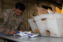 Airman Joseph Romero, Traffic Management Office(TMO) inbound cargo technician, confirms an invoice at Minot Air Force Base, North Dakota, Jun 3, 2025. The TMO manages and safeguards supplies and goods essential to Team Minot’s mission. (U.S. Air Force Senior Airmen Alex Nottingham)
