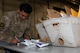 Airman Joseph Romero, Traffic Management Office(TMO) inbound cargo technician, confirms an invoice at Minot Air Force Base, North Dakota, Jun 3, 2025. The TMO manages and safeguards supplies and goods essential to Team Minot’s mission. (U.S. Air Force Senior Airmen Alex Nottingham)
