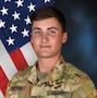 Male Soldier posing in front of U.S. flag