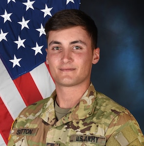 Male Soldier posing in front of U.S. flag