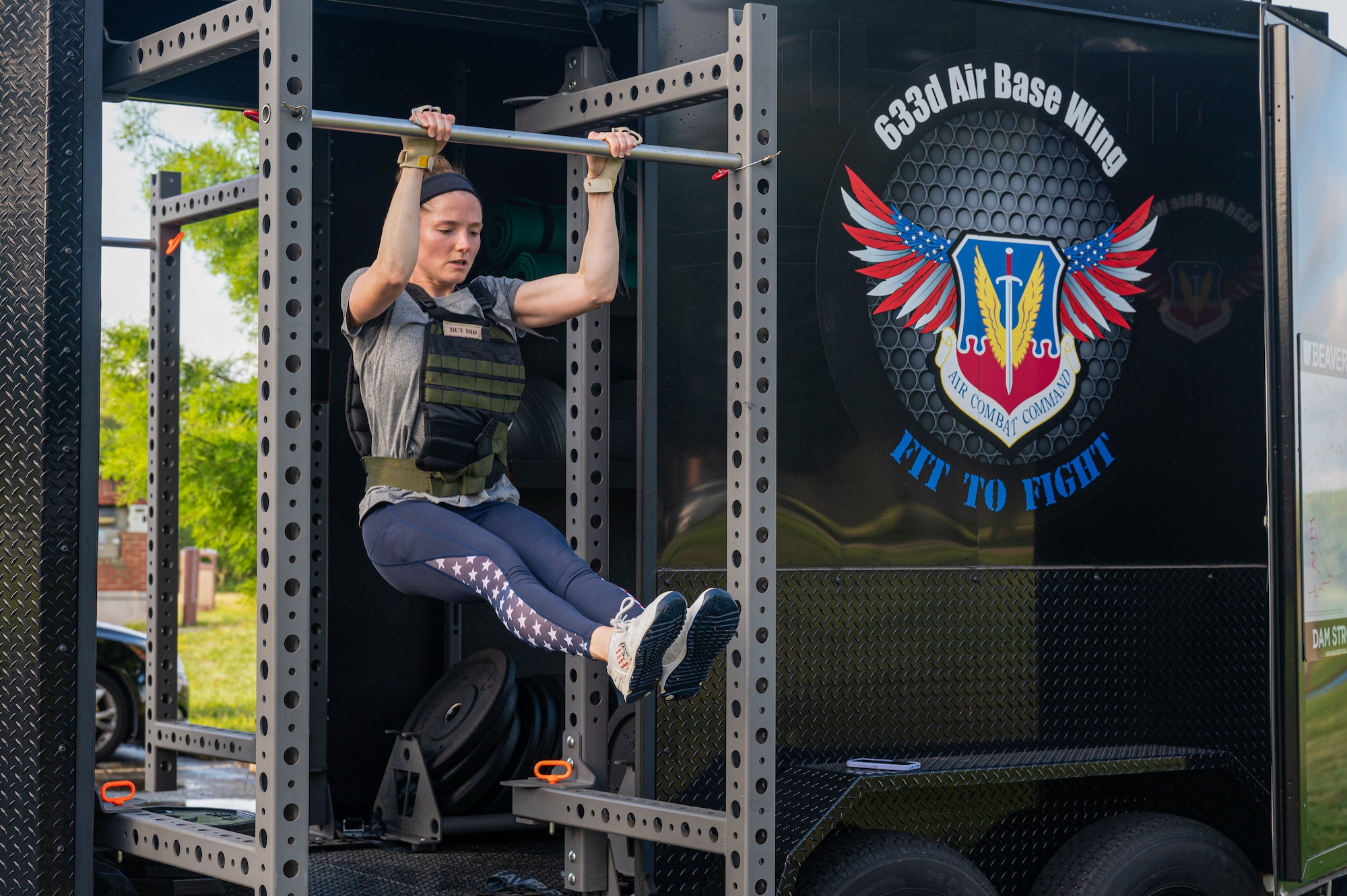 Woman does pull-up.