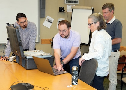 JOINT BASE SAN ANTONIO-FORT SAM HOUSTON – (May 22, 2025) – Josh Johnston, SteriO3 project manager, joined by SteriO3 CEO Dr. Steve Hughes, provides instructions on updating the software on the Rugged Ozone Sterilization System Model M1 (ROSS M1) to Naval Medical Research Unit (NAMRU) San Antonio principal investigator Andres Martinez Murillo (left) and research scientist Tarea Burton at the Battlefield Health and Trauma Research Institute.  Navy Medicine Research & Development (NMR&D) employs highly qualified medical researchers and works alongside a wide range of research and development partners to keep abreast of best practices and advances in medical knowledge on behalf of Navy Medicine to increase warfighter lethality. NAMRU San Antonio has been collaborating with SteriO3 since 2021. NAMRU San Antonio, part of NMR&D, conducts gap-driven combat casualty care, craniofacial, and directed energy research in support of Navy, Marine Corps and joint U.S. warfighter health readiness and lethality while engaged in routine and expeditionary operations. (U.S. Navy Photo by Burrell Parmer, NAMRU San Antonio Public Affairs/Released)