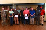 Col. Beau Mason, Virginia National Guard construction and facilities management officer, Lt. Col. Eric Quinn, Fort Barfoot garrison commander, and retired Col. Everton E. Nevers, the Virginia Department of Military Affairs Chief of Staff, present awards to DMA workers as part of a state employee recognition luncheon May 22, 2025, at Fort Barfoot, Virginia. During the presentation, DMA employees were recognized for both agency-level accomplishments as well as for service anniversaries. Quinn and Nevers gave remarks during the event, thanking the installation’s state workers for their hard work supporting the VNG and other organizations training at the installation. (U.S. National Guard photo by A.J. Coyne)