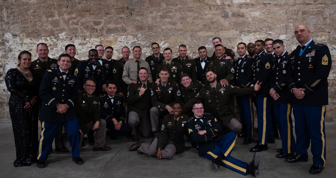 Members from the 344th Military Intelligence Battalion, Alpha Company, pose for a group photo during the 250th Army Birthday Ball at The Stables Block at Fort Concho, San Angelo, Texas, June 6, 2025. The 344th MIB’s mission is to train Soldiers in the Military Intelligence and Cyber career fields through discipline, physical fitness and technical competence instilled with Army values. (U.S. Air Force photo by Airman 1st Class Brian Lummus)