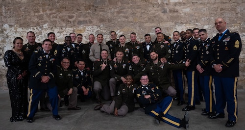 Members from the 344th Military Intelligence Battalion, Alpha Company, pose for a group photo during the 250th Army Birthday Ball at The Stables Block at Fort Concho, San Angelo, Texas, June 6, 2025. The 344th MIB’s mission is to train Soldiers in the Military Intelligence and Cyber career fields through discipline, physical fitness and technical competence instilled with Army values. (U.S. Air Force photo by Airman 1st Class Brian Lummus)