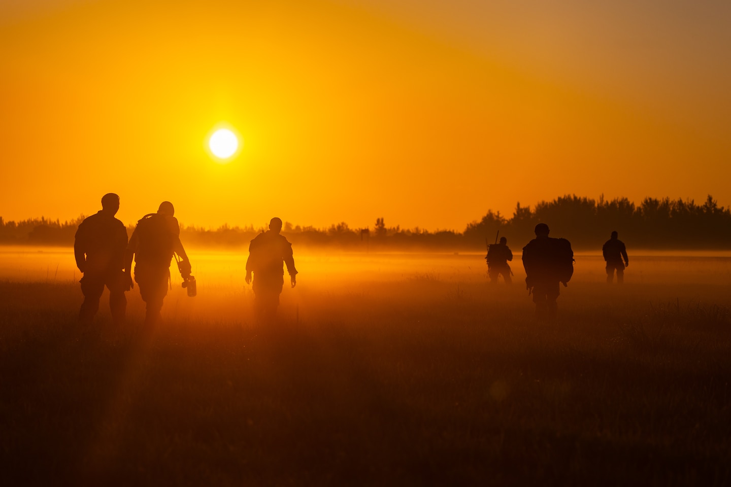 In the early morning hours, U.S. Army soldiers assigned to the 478th Civil Affairs Battalion, and paratroopers assigned to the British 4th Battalion, walk across a field, heading back to an awaiting vehicle after conducting a jump and land operations during Lagoon Leap 2025, at Homestead Air Base, Fla., May 14-16th, 2025.(U.S. Army photo by Staff Sgt. Tarako Braswell)