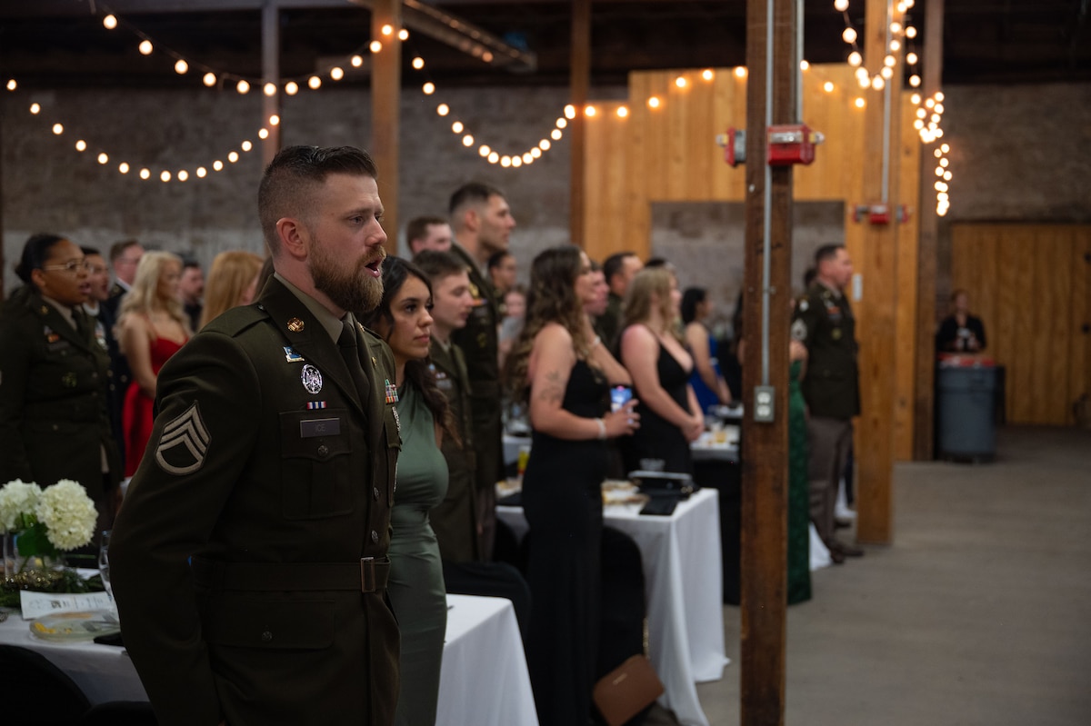 U.S. Army Staff Sgt. Colton Ice, 344th Military Intelligence Battalion instructor, sings “The Army Goes Rolling Along,” during the 250th Army Birthday Ball at The Stables Block at Fort Concho, San Angelo, Texas, June 6, 2025. The singing of the Army song, “The Army Goes Rolling Along,” is performed at the conclusion of every U.S. Army ceremony since its adoption in 1952. (U.S. Air Force photo by Airman 1st Class Brian Lummus)
