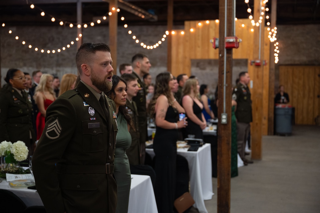 U.S. Army Staff Sgt. Colton Ice, 344th Military Intelligence Battalion instructor, sings “The Army Goes Rolling Along,” during the 250th Army Birthday Ball at The Stables Block at Fort Concho, San Angelo, Texas, June 6, 2025. The singing of the Army song, “The Army Goes Rolling Along,” is performed at the conclusion of every U.S. Army ceremony since its adoption in 1952. (U.S. Air Force photo by Airman 1st Class Brian Lummus)