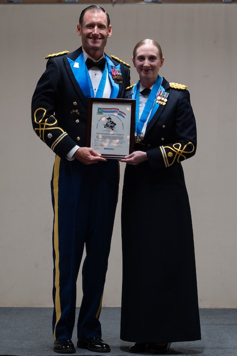 U.S. Army Maj. Elisabeth Hallgreen, 344th Military Intelligence Battalion executive officer, receives the Knowlton Award from U.S. Army Lt. Col. Raymond Kuderka, 344th Military Intelligence Battalion commander during the 250th Army Birthday Ball at The Stables Block at Fort Concho, San Angelo, Texas, June 6, 2025. The Knowlton Award recognizes individuals who have contributed to the promotion of Military Intelligence through integrity, moral character, professional competence and serve the MI Corps with distinction. (U.S. Air Force photo by Airman 1st Class Brian Lummus)