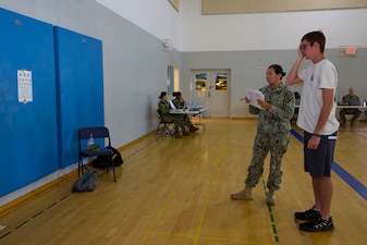250529-N-FT324-4023. ROTA, Spain. May 29, 2025. Hospital Corpsman Third Class Ashley Vasquez, Corpsman, U.S. Naval Hospital Rota Optometry Clinic, assesses a student’s visual acuity during the annual sports physical fair at the school. The event ensures students are healthy and ready to participate in sports for the upcoming year, highlighting the strength of partnership and outreach with local community schools. (U.S. Navy Photo by Mr. Everett Lopez/ Released by Lt. Cmdr. Alicia Sacks)