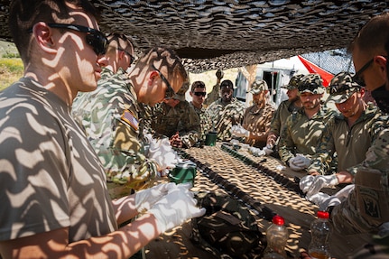 U.S. Soldiers with the 572nd Brigade Engineer Battalion, 86th Infantry Brigade Combat Team (Mountain), Vermont National Guard, and Austrian Land Forces assemble brazier charges used to breach wire barriers as part of Immediate Response 25 during DEFENDER 25