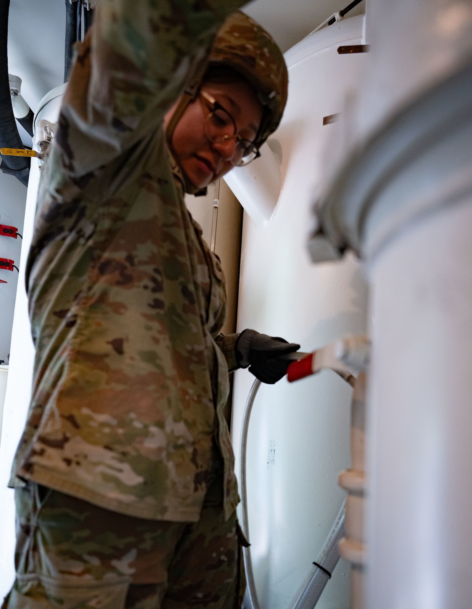 U.S. Army Reserve Pfc. Maribel Valentin, 810th Quartermaster Company water treatment specialist, purifies water during the Quartermaster Liquid Logistics Exercise.
