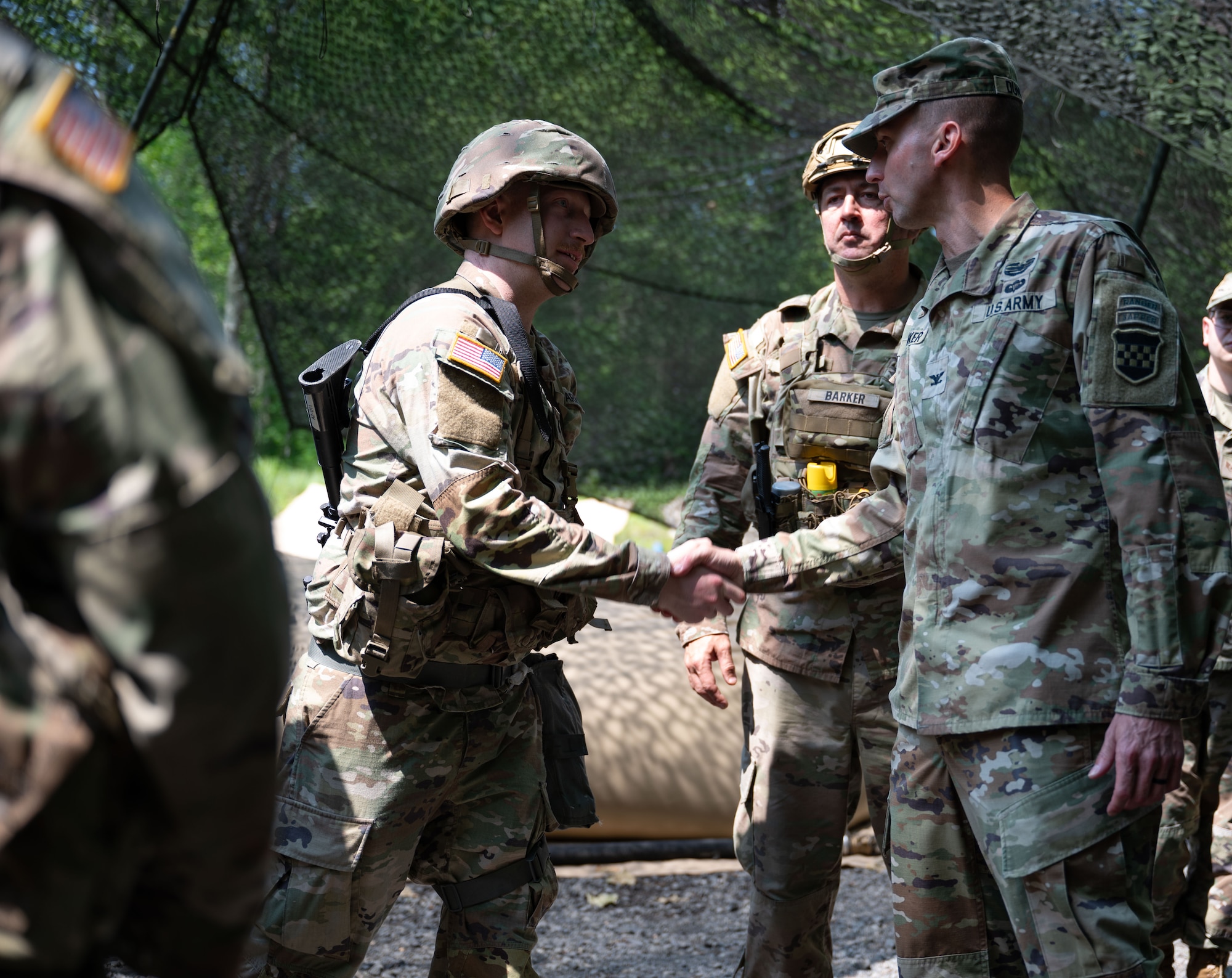 U.S. Army Col. Bryan Dunker (right), Joint Base McGuire-Dix-Lakehurst deputy commander and U.S. Army Support Activity commander, coins Army Reserve Sgt. Micah McHenry, 810th Quartermaster Company water treatment specialist, during the Quartermaster Liquid Logistics Exercise.