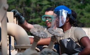 U.S. Army Reserve Staff Sgt. Brandon Johnson (left) and Spc. Asenuga Omobowale, 233rd Quartermaster Company petroleum supply specialists, maintain fuel equipment during the Quartermaster Liquid Logistics Exercise.