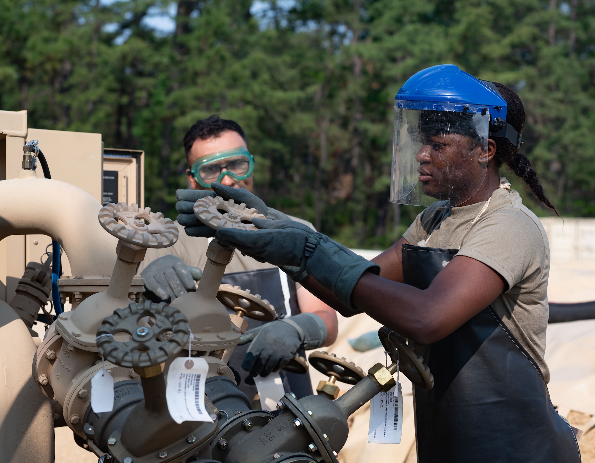 U.S. Army Reserve Spc. Asenuga Omobowale (right) and Staff Sgt. Brandon Johnson, 233rd Quartermaster Company petroleum supply specialists, maintain fuel equipment at the Fuel System Supply Point during the Quartermaster Liquid Logistics Exercise.