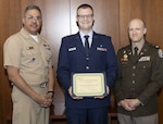 U.S. Navy Capt. Juan Rosario (left), Chief of Staff at Walter Reed National Military Medical Center, and U.S. Army Lt. Col. Michael Orestes (right), Director for Education, Training and Research at Walter Reed, recognize U.S. Air Force (Dr.) Capt. Kiffin Smallegan, of the Department of Pediatrics, for earning first place in the Department of Research Programs' annual poster competition in the evidence-based practice category. The annual competition highlights research conducted by Walter Reed's staff, interns, residents and fellows.