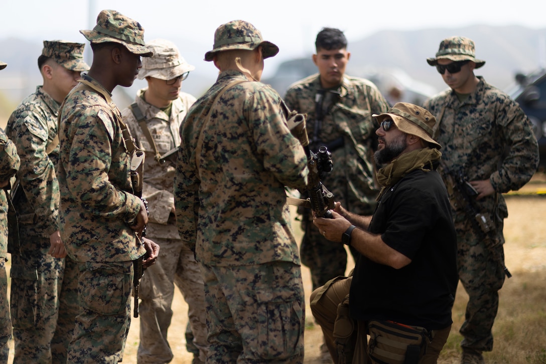 John Pothos, a system analyst with Saab, demonstrates the proper set up of a Marine Corps Tactical Instrumentation System during an air raid course hosted by the Amphibious Raids Branch, Expeditionary Operations Training Group, I Marine Expeditionary Force, at Marine Corps Base Camp Pendleton, California, June 2, 2025.
