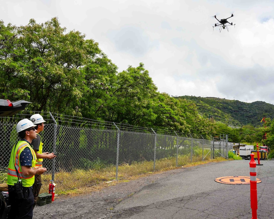 A drone operator monitors in-flight data sent by a heavy lift drone fitted with a laser sensor called a LiDAR, or light detection and ranging, at the Red Hill Bulk Fuel Storage Facility (RHBFSF) in Honolulu, May 16, 2025. The operation was part of an ongoing joint effort between Navy Closure Task Force-Red Hill (NCTF-RH), the Expeditionary Warfare Center, and Naval Information Warfare Center Atlantic to create a 3D map of the RHBFSF. Charged with the safe decommissioning of the facility, NCTF-RH was established by the Department of the Navy as a commitment to the community and the environment. NCTF-RH continues to engage with the people of Hawaii, regulatory agencies, and other stakeholders as it safely and deliberately decommissions the RHBFSF. (U.S. Navy photo by Mass Communication Specialist 1st Class Glenn Slaughter)
