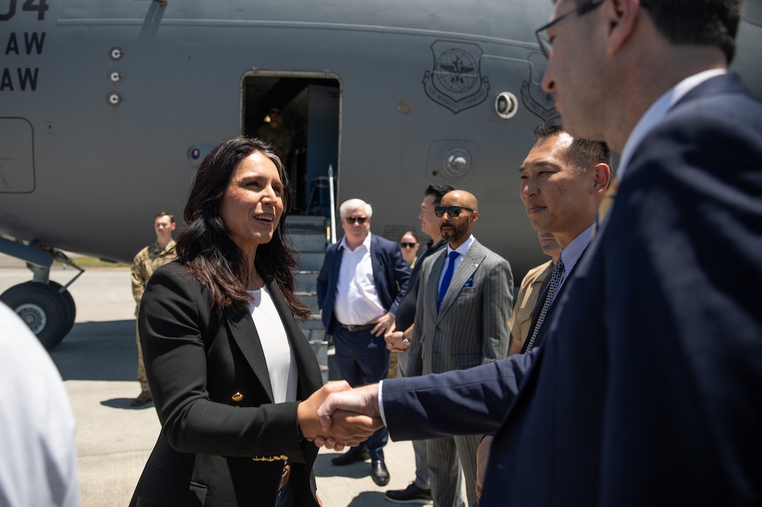 The Director of National Intelligence, Tulsi Gabbard, shakes hands with Patrick McEachern, Director of Digital Media, U.S. Embassy Tokyo, during a visit to Marine Corps Air Station Iwakuni, Japan, June 4, 2025. Director Gabbard and U.S. Ambassador to Japan, George Glass, visited MCAS Iwakuni to learn about the air station's capabilities, meet with U.S. Marines and Sailors, and observe the strong partnership between the United States and Japan.​​ (U.S. Marine Corps photo by Cpl. Colin Thibault)