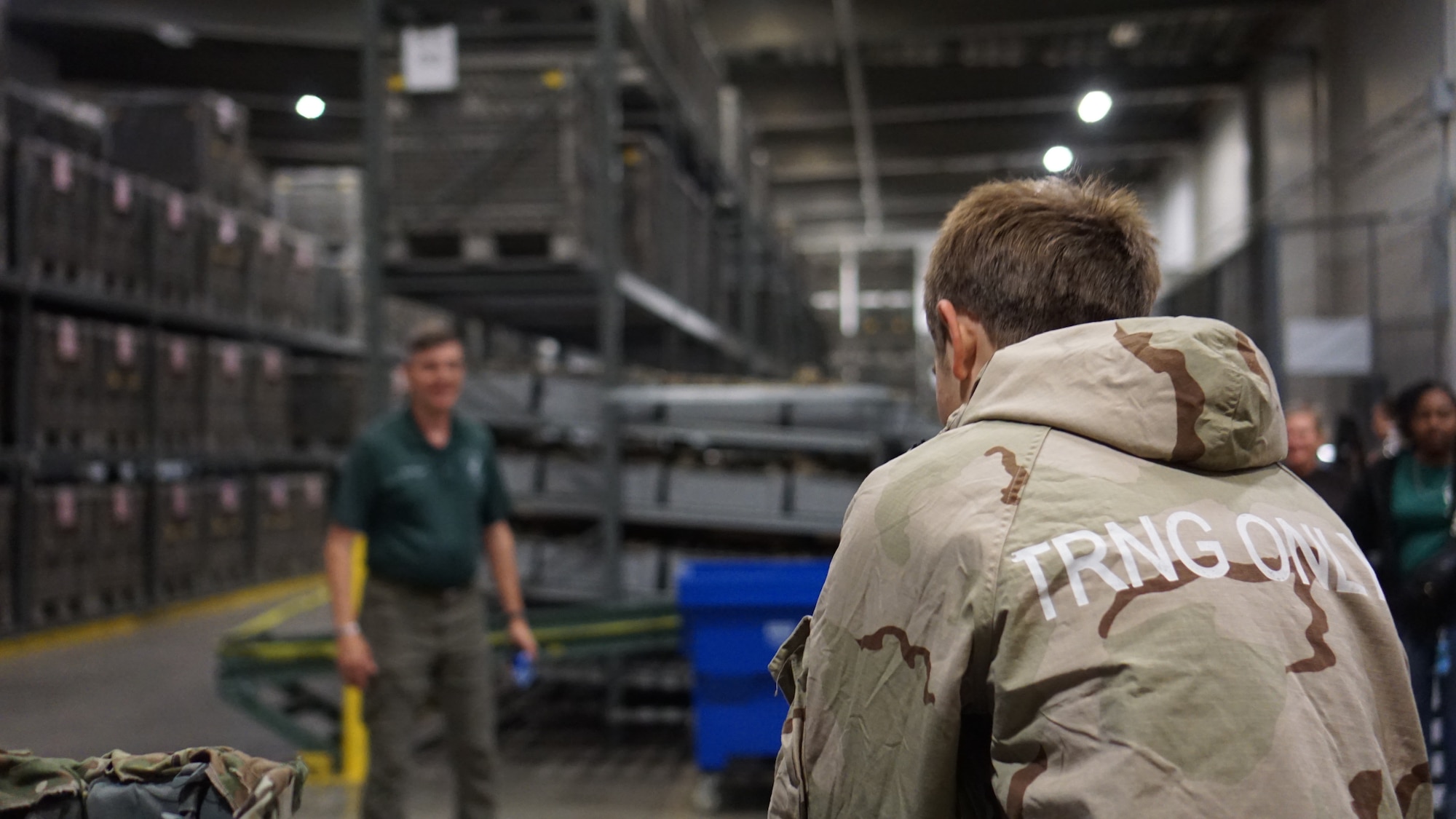 A Junior ROTC cadet tries on individual protective equipment during a visit to the base.