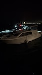 A white boat used to smuggle migrants is seen moored up to a pier.