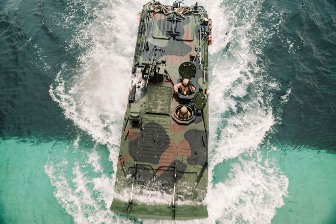 A U.S. Marine Corps amphibious combat vehicle attached to 3rd Assault Amphibian Battalion, 1st Marine Division, drives onto the well deck of the amphibious dock landing ship USS Harpers Ferry (LSD 49), during Quarterly Underway Amphibious Readiness Training 25.3 while underway in the Pacific Ocean, May 28, 2025. QUART is a joint training exercise designed to develop and sustain essential amphibious readiness skills for effective operations in maritime environments while reinforcing the Navy-Marine Corps partnership. (U.S. Marine Corps photo by Cpl. Luis Agostini)