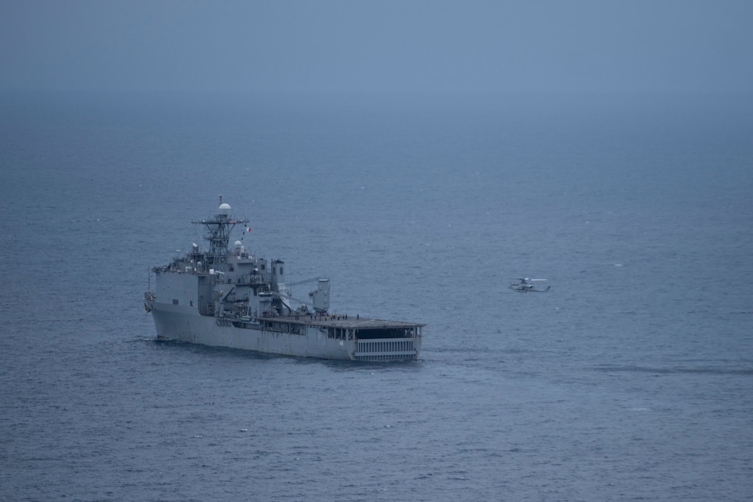 The amphibious landing dock USS Harpers Ferry (LSD 49) prepares to receive a U.S. Marine Corps AH-1Z Viper for deck landing qualifications during Quarterly Underway Amphibious Readiness Training 25.3 at off the coast of Marine Corps Base Camp Pendleton, California, June 3, 2025.