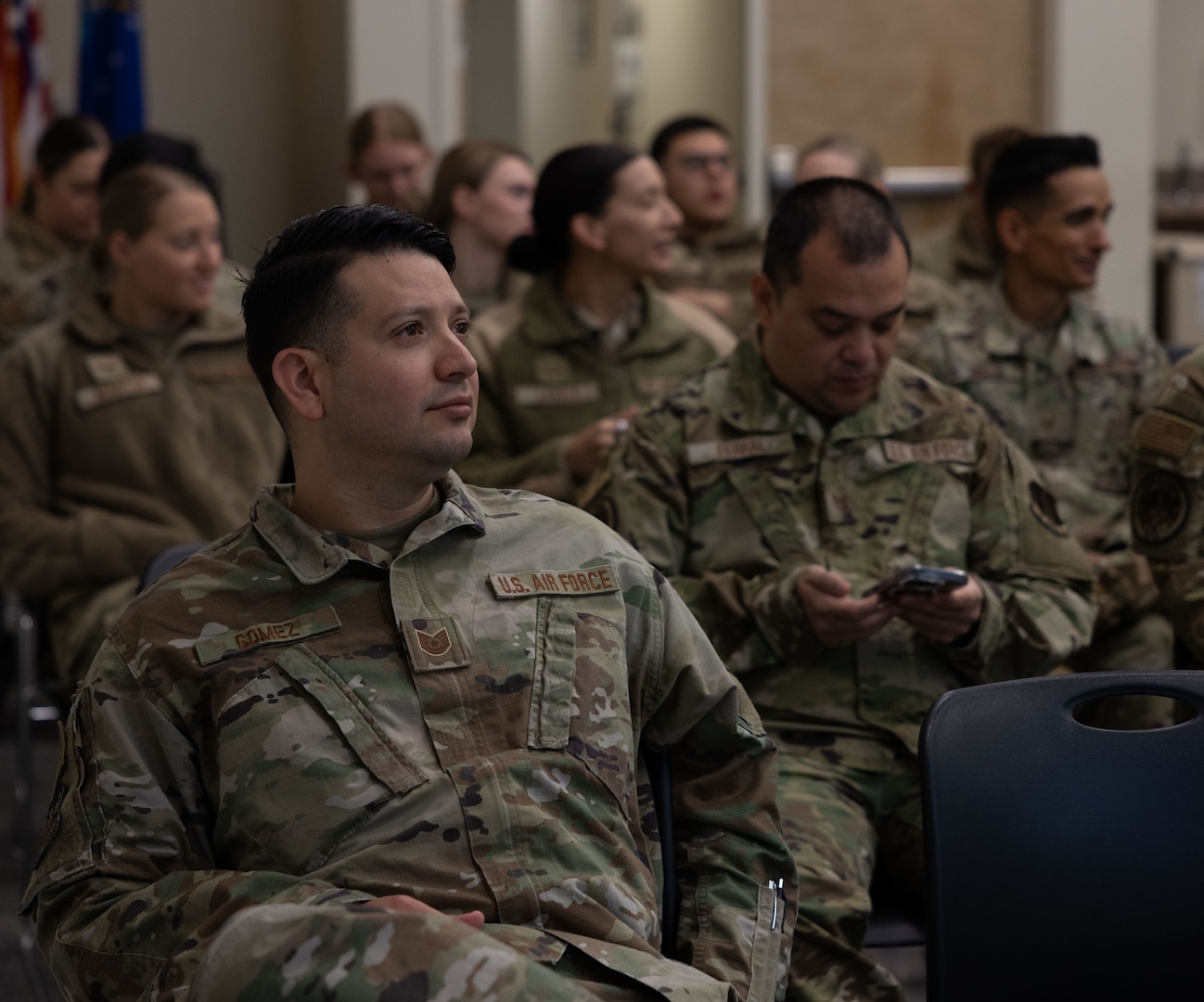 U.S. Air National Guard Tech. Sgt. Juan Gomez, a Health Administration Services specialist with the 162nd Medical Group, listens during a welcome briefing at Joint Base Elmendorf-Richardson as part of Medical Facilities Annual Training, June 9, 2025. MFAT fosters interoperability between Air National Guard and active duty medical personnel, strengthening coordination and readiness across the total force. (U.S. Air National Guard photo by Staff Sgt. Guadalupe Beltran)