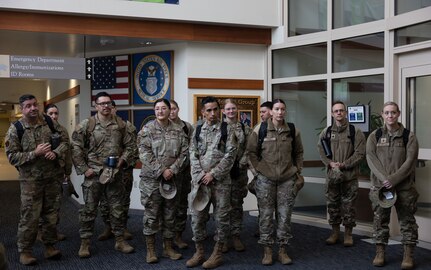 U.S.Air National Guard members assigned to the 162nd Wing gather for a hospital facilities tour at Joint Base Elmendorf-Richardson, Alaska, June 9, 2025. The two-week training event enhances clinical readiness and promotes joint integration by embedding Air National Guard personnel alongside active-duty medical teams in a real-world hospital setting. (U.S. Air National Guard photo by Staff Sgt. Guadalupe Beltran)