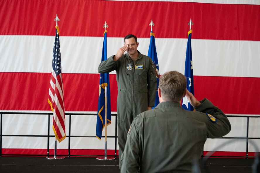 Col. Charles Huber, 10th Air Force Deputy Director of Operations and Plans, renders the customary first salute to Brig. Gen. Kevin Merrill during the 10th Air Force change of command ceremony at Naval Air Station Joint Reserve Base Fort Worth, Texas, June 8, 2025.