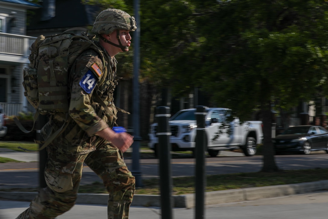 U.S. Army Spc. Syrus Butts, a cannon crewmember with Bravo Battery, 2nd Battalion, 138th Field Artillery, participates in the 12-mile ruck march of the Best Warrior Competition (BWC), Region III phase, ending at the Citadel in Charleston, South Carolina, April 23, 2025.