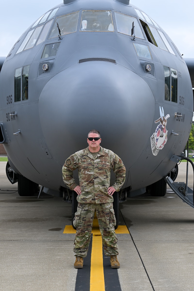 Master Sgt. Dan Scott, a dedicated crew chief assigned to the 910th Aircraft Maintenance Squadron, poses for a photo in front of aircraft 9106 prior to its final flight from Youngstown Air Reserve Station, Ohio, as a 910th Airlift Wing aircraft, June 9, 2025.
