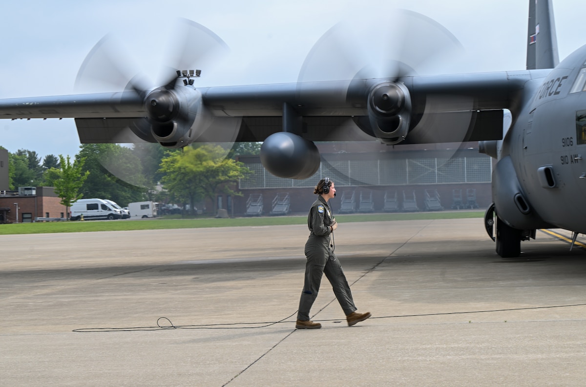 Senior Airman Alexis Youngblood, a loadmaster assigned to the 757th Airlift Squadron, watches aircraft 9106’s engines start up prior to its final flight from Youngstown Air Reserve Station, Ohio, as a 910th Airlift Wing aircraft, June 9, 2025.