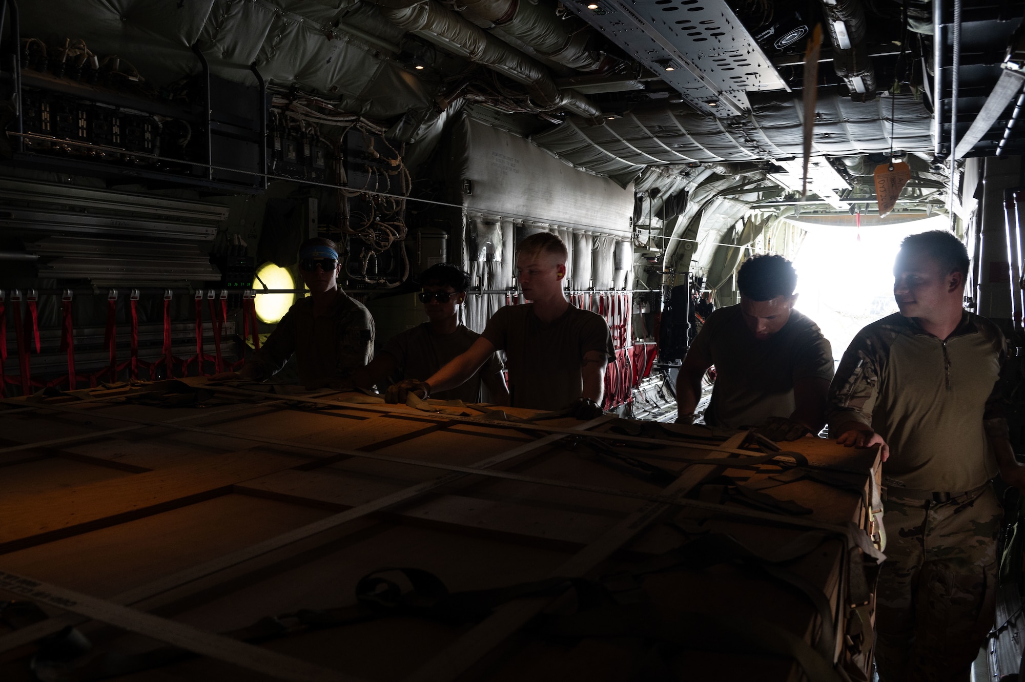 U.S. Air Force Airmen assigned to the 40th Airlift Squadron and the 8th Expeditionary Aerial Mobility Squadron load cargo onto a C-130J in the U.S. Central Command area of responsibility, June 7, 2025. The C-130 can accommodate a wide variety of oversized cargo, including utility helicopters, six-wheeled armored vehicles and standard palletized cargo along with military personnel. (U.S. Air Force photo by Senior Airman Dieondiere Jefferies)
