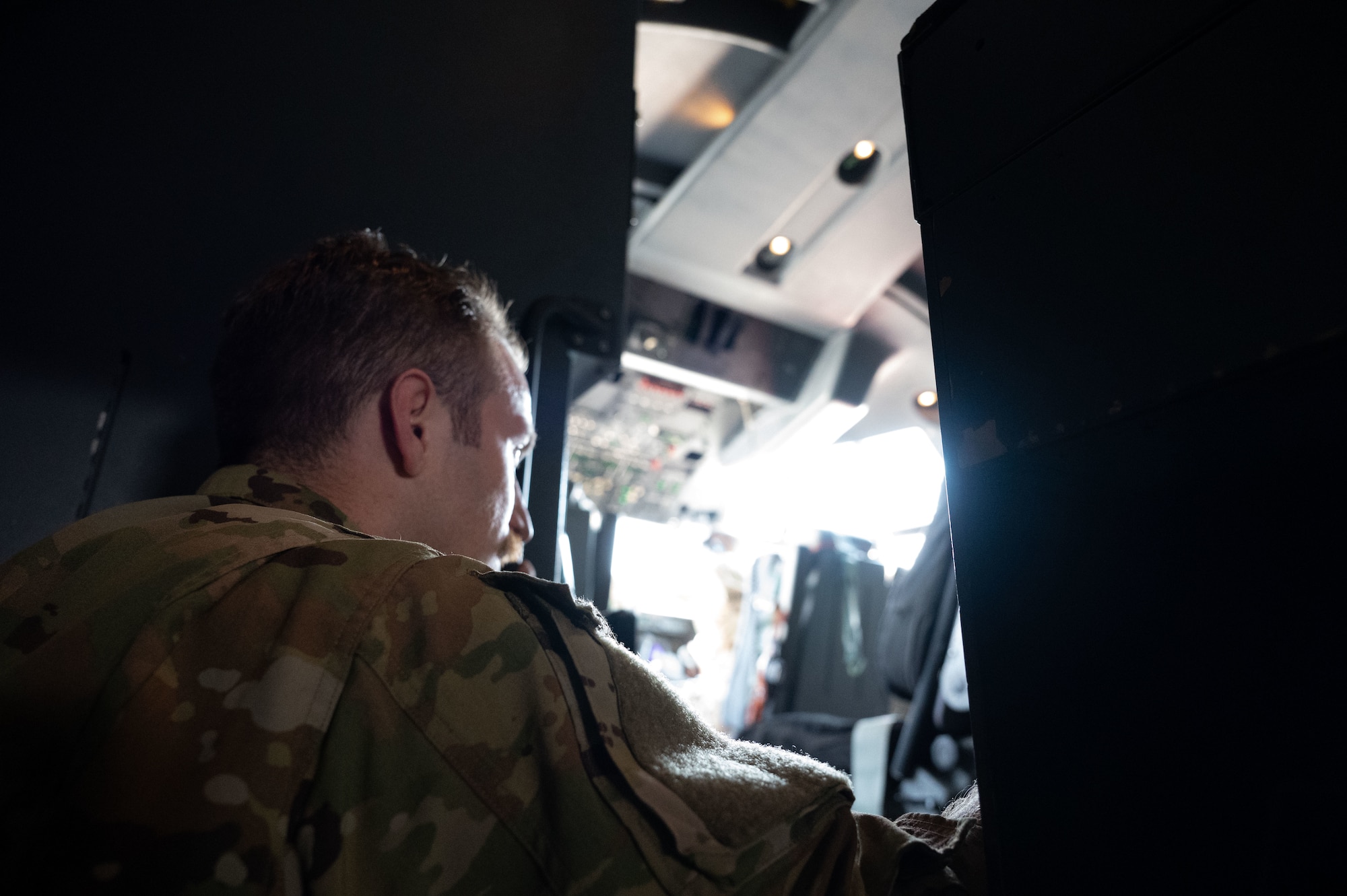 A U.S. Air Force pilot assigned to the 40th Airlift Squadron climbs up to the flight deck of a C-130J within the U.S. Central Command area of responsibility, June 6, 2025. The 40th AS mission includes transporting personnel, equipment, and supplies and supporting humanitarian and contingency operations across the globe. (U.S. Air Force photo by Senior Airman Dieondiere Jefferies)