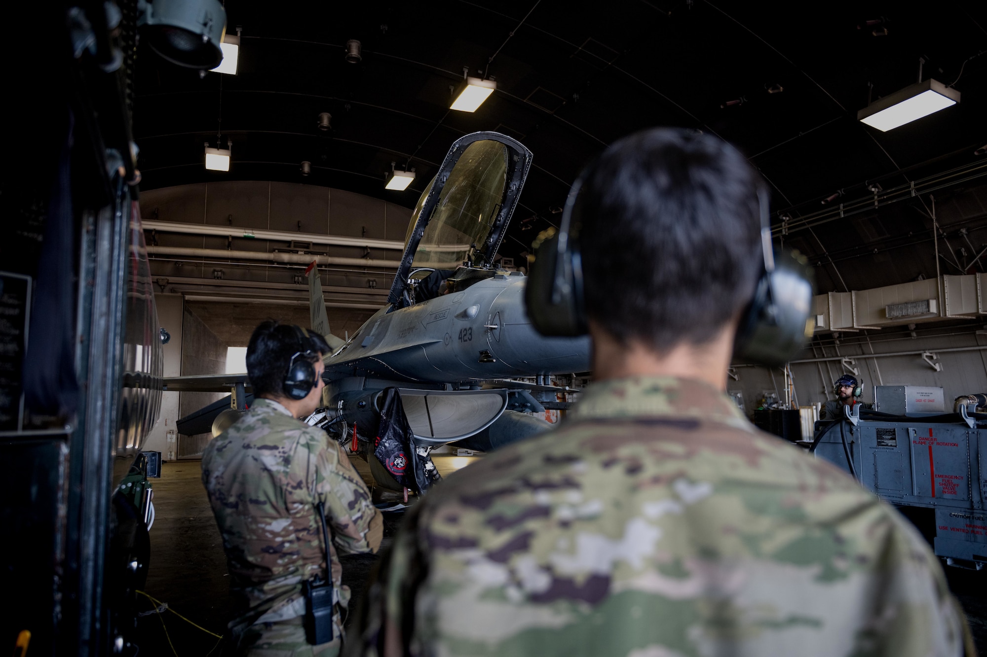 U.S. Air Force Airman 1st Class Andrews Mikel, right, and U.S. Air Force Senior Airman Jose Pro, 35th Logistic Readiness Squadron fuels distribution operators, watch for an F-16 Fighting Falcon crew chief’s signal to start fueling at Misawa Air Base, June 10, 2025.
