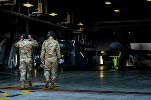 U.S. Air Force Senior Airman Jose Pro, left, and U.S. Air Force Airman 1st Class Andrews Mikel, 35th Logistic Readiness Squadron fuels distribution operators, approach an R-11 fueling truck and F-16 Fighting Falcon for a fuel run at Misawa Air Base, June 10, 2025.