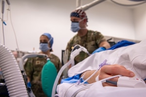 U.S. Air Force Maj. Sandrela Magnuson, 379th Expeditionary Medical Squadron nurse staging facility officer in charge, left, and Maj. Matthew Gritis, 379th Expeditionary Medical Squadron nurse anesthesiologist, monitor a patient’s vitals during surgery within the U.S. Central Command area of responsibility, June 5, 2025. The 379th EMDS provides comprehensive post-operative care to ensure recovery and minimize complications; including wound care, monitoring for signs of infection and managing pain. (U.S. Air Force photo by Staff Sgt. Sean Moriarty)