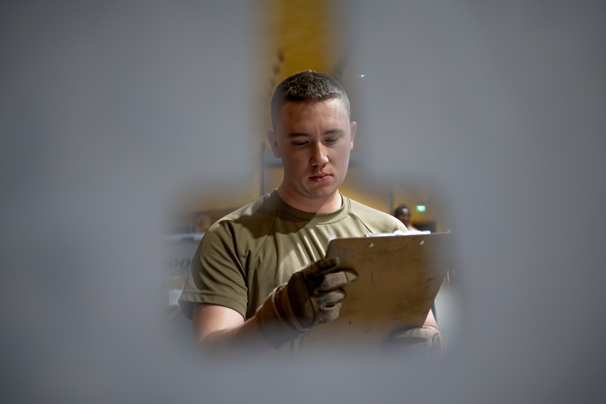 Airman reviews an equipment maintenance log