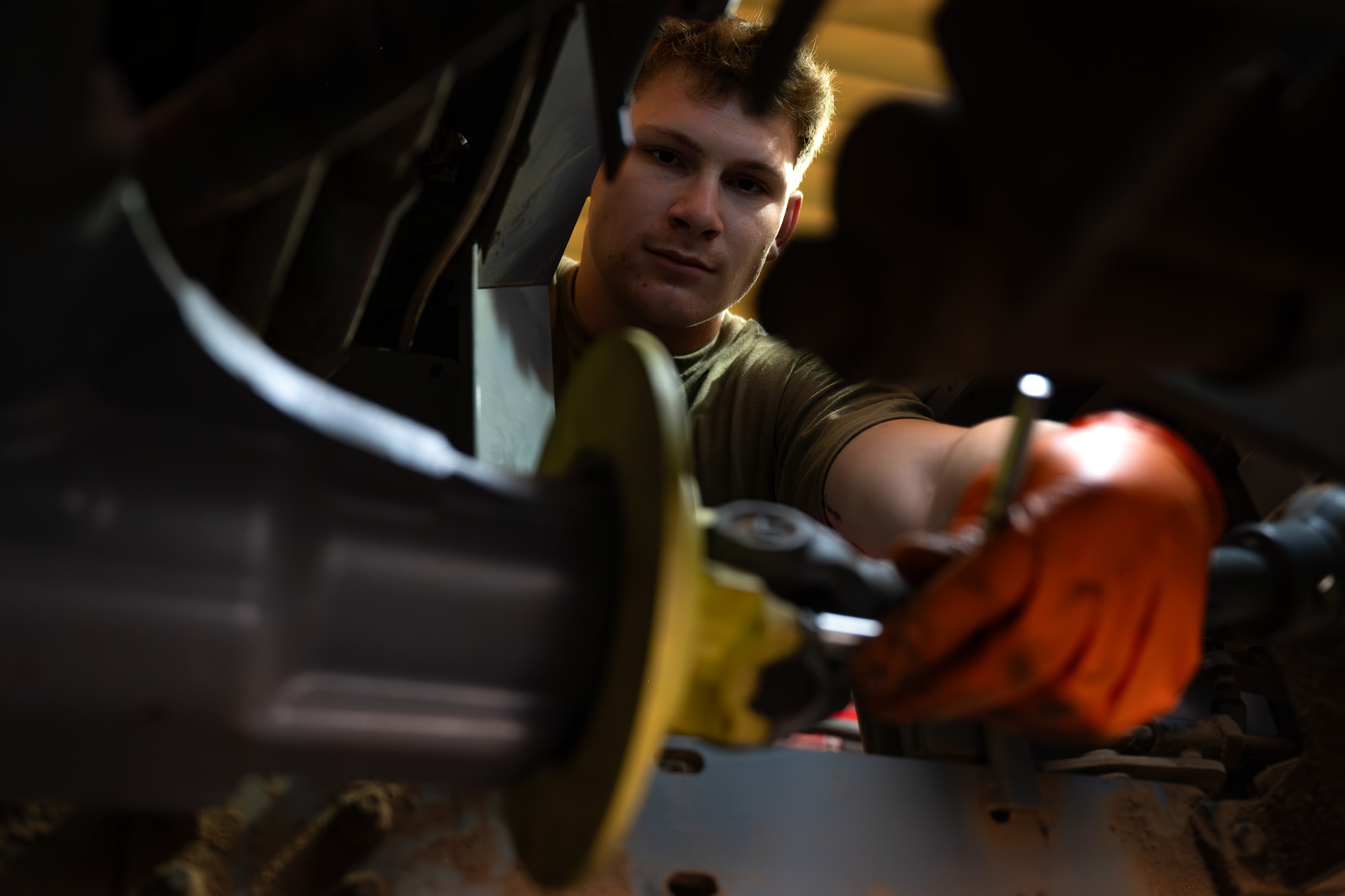 Airman tightens a bolt on a brake disc