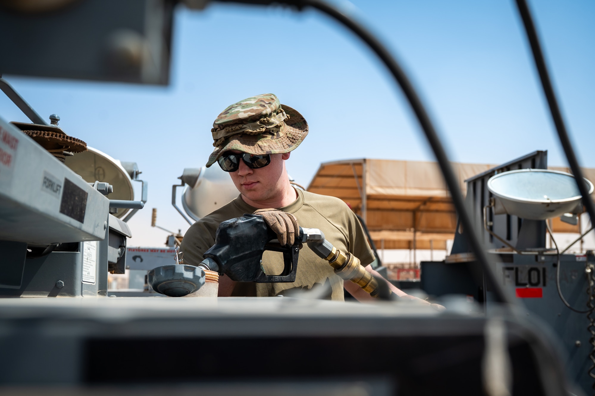 Airman fuels a flood light on a flightline