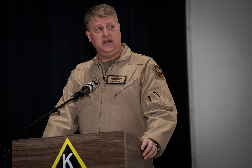 U.S. Air Force Maj. Gen. David Shoemaker, 9th Air Force (Air Forces Central) deputy commander, gives opening remarks during the 379th Air Expeditionary Wing Change of Command Ceremony within the U.S. Central Command area of responsibility, June 5, 2025. The ceremony saw Brig. Gen. Richard Dickens, 379th AEW outgoing commander, relinquish command to Brig. Gen. Travis Edwards, incoming 379th AEW commander. (U.S. Air Force photo by Staff Sgt. Sean Moriarty)