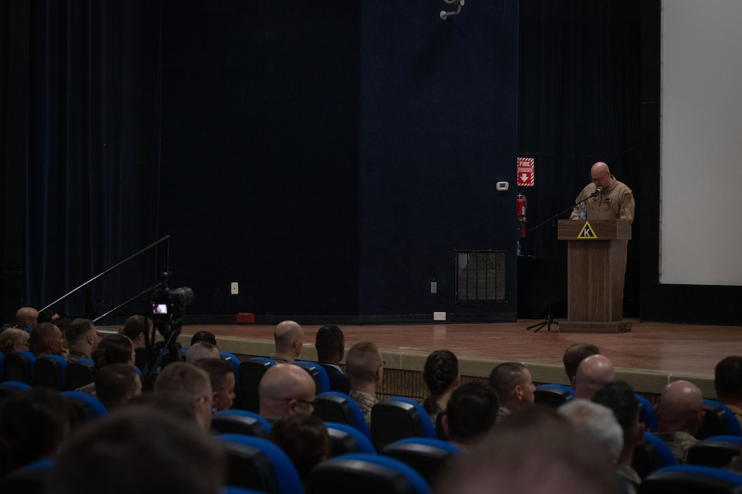 U.S. Air Force Brig. Gen. Richard Dickens, 379th Air Expeditionary Wing outgoing commander, gives departing remarks during the 379th AEW Change of Command Ceremony within the U.S. Central Command area of responsibility, June 9, 2025. The 379th AEW is tasked to generate, support and sustain coalition airpower. (U.S. Air Force photo by Staff Sgt. Sean Moriarty)
