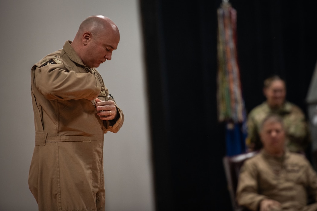 U.S. Air Force Brig. Gen. Richard Dickens, 379th Air Expeditionary Wing commander, bows his head after finishing his closing remarks during the 379th AEW Change of Command Ceremony within the U.S. Central Command area of responsibility, June 9, 2025. The 379th AEW is tasked to generate, support and sustain coalition airpower. (U.S. Air Force photo by Staff Sgt. Sean Moriarty)