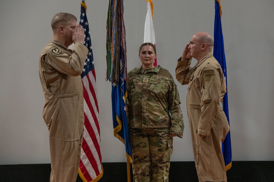 U.S. Air Force Brig. Gen. Richard Dickens, right, 379th Air Expeditionary Wing outgoing commander, salutes Maj. Gen. David Shoemaker, 9th Air Force (Air Forces Central) deputy commander, during the 379th AEW Change of Command Ceremony within the U.S. Central Command area of responsibility, June 9, 2025. The 379th AEW provides support to more than 5,400 Air Force, joint and coalition force partners. (U.S. Air Force photo by Staff Sgt. Sean Moriarty