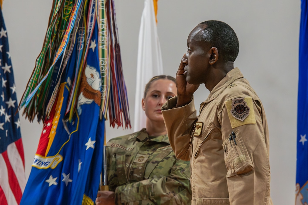 U.S. Air Force Brig. Gen. Travis Edwards, right, 379th Air Expeditionary Wing incoming commander, renders salute during the 379th AEW Change of Command Ceremony within the U.S. Central Command area of responsibility, June 9, 2025. Edwards earned his commission as a distinguished graduate through the Reserve Officer Training Corps in 1996. (U.S. Air Force photo by Staff Sgt. Sean Moriarty)