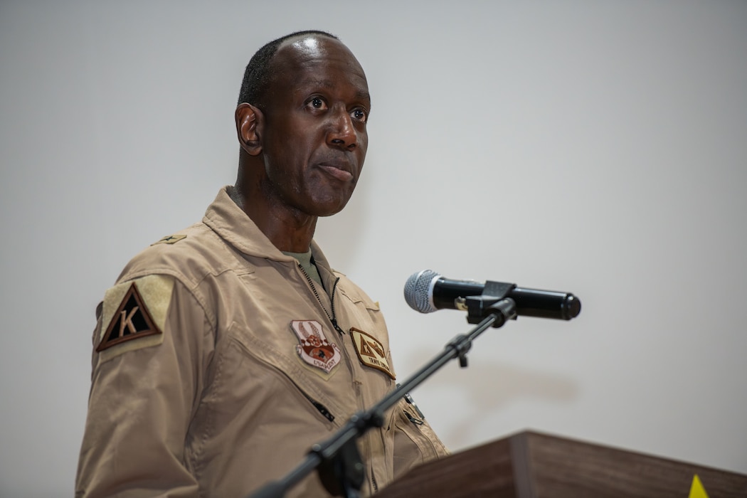 U.S. Air Force Brig. Gen. Travis Edwards, 379th Air Expeditionary Wing incoming commander, gives a speech during the 379th AEW Change of Command Ceremony within the U.S. Central Command area of responsibility, June 9, 2025. Edwards earned his commission as a distinguished graduate through the Reserve Officer Training Corps in 1996. (U.S. Air Force photo by Staff Sgt. Sean Moriarty)