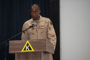 U.S. Air Force Brig. Gen. Travis Edwards, 379th Air Expeditionary Wing incoming commander, gives a speech during the 379th AEW Change of Command Ceremony within the U.S. Central Command area of responsibility, June 9, 2025. The ceremony saw Edwards assume command from Brig. Gen. Richard Dickens. (U.S. Air Force photo by Staff Sgt. Sean Moriarty)