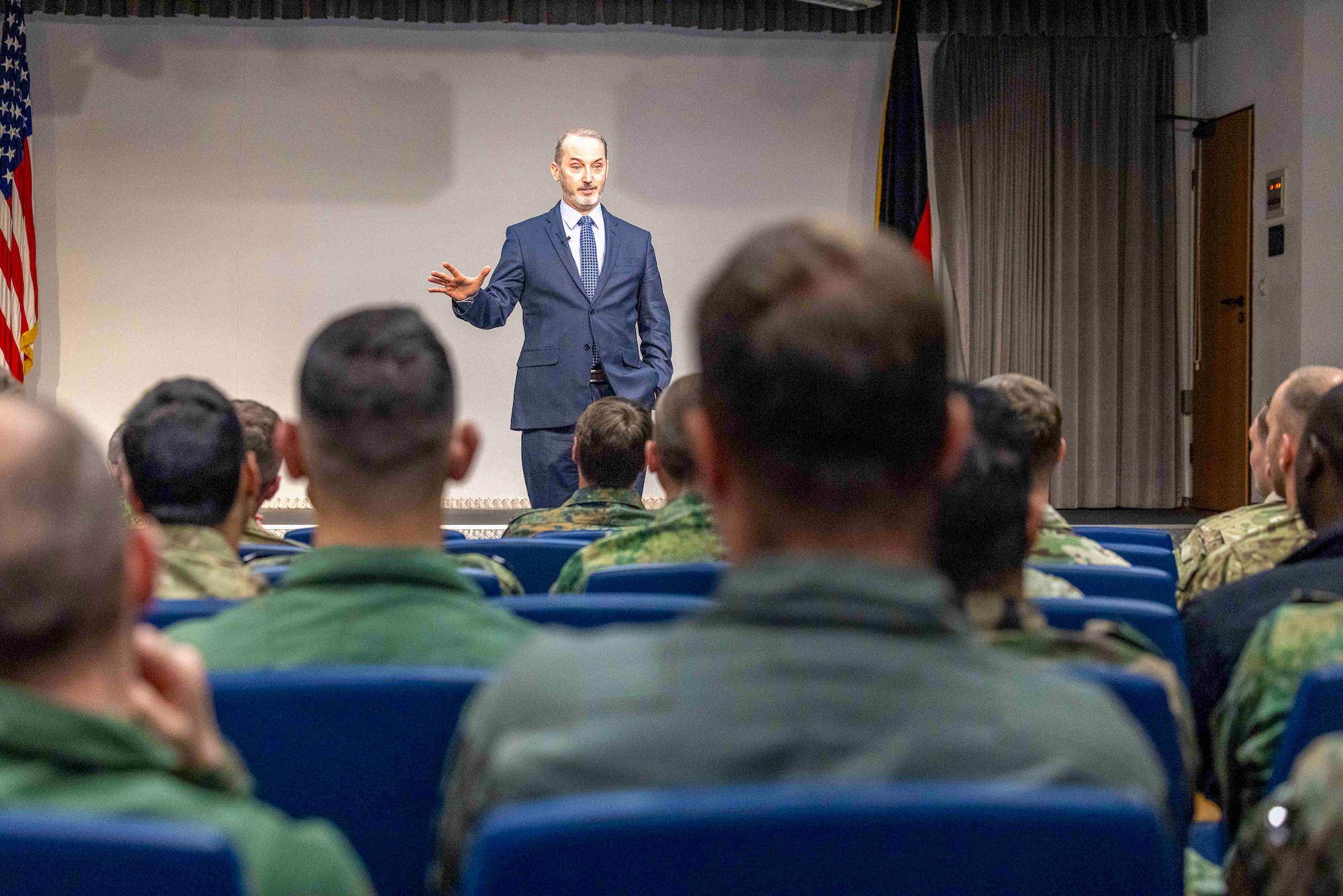 Retired U.S. Air Force Senior Master Sgt. Travis Robbins speaks to the U.S. Inter-European Air Forces Academy Class 25B students at Kisling Auditorium, Kapaun Air Station, Germany, May 19, 2025. Robbins, who helped build IEAFA from the ground up, urged students to lead with urgency and purpose, reminding them that coalitions only succeed when preparation becomes habit. (Photo by Terrance Rhodes, IEAFA Strategic Communications Analyst)